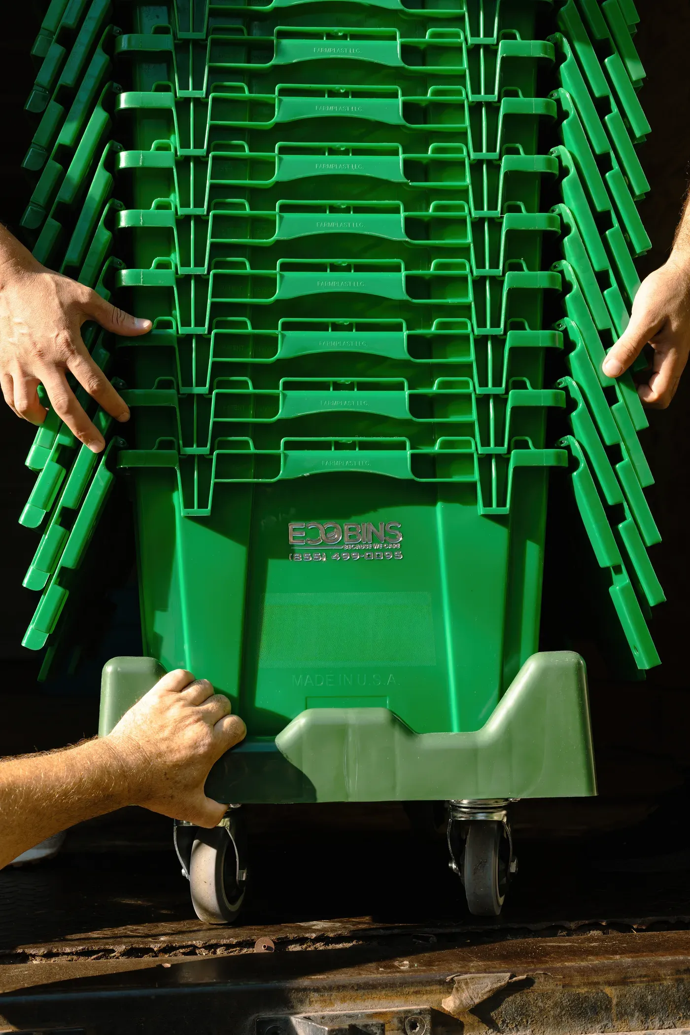 Green EcoBins bins stacked on a rolling cart