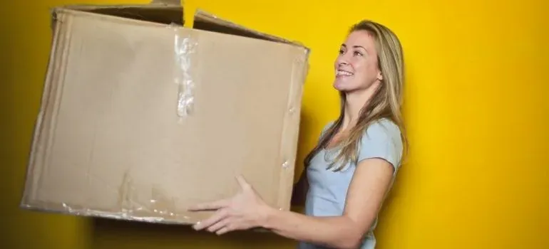 A dog sitting among moving boxes in a New Jersey home