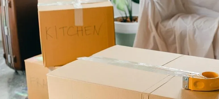 Labeled kitchen moving boxes with tape