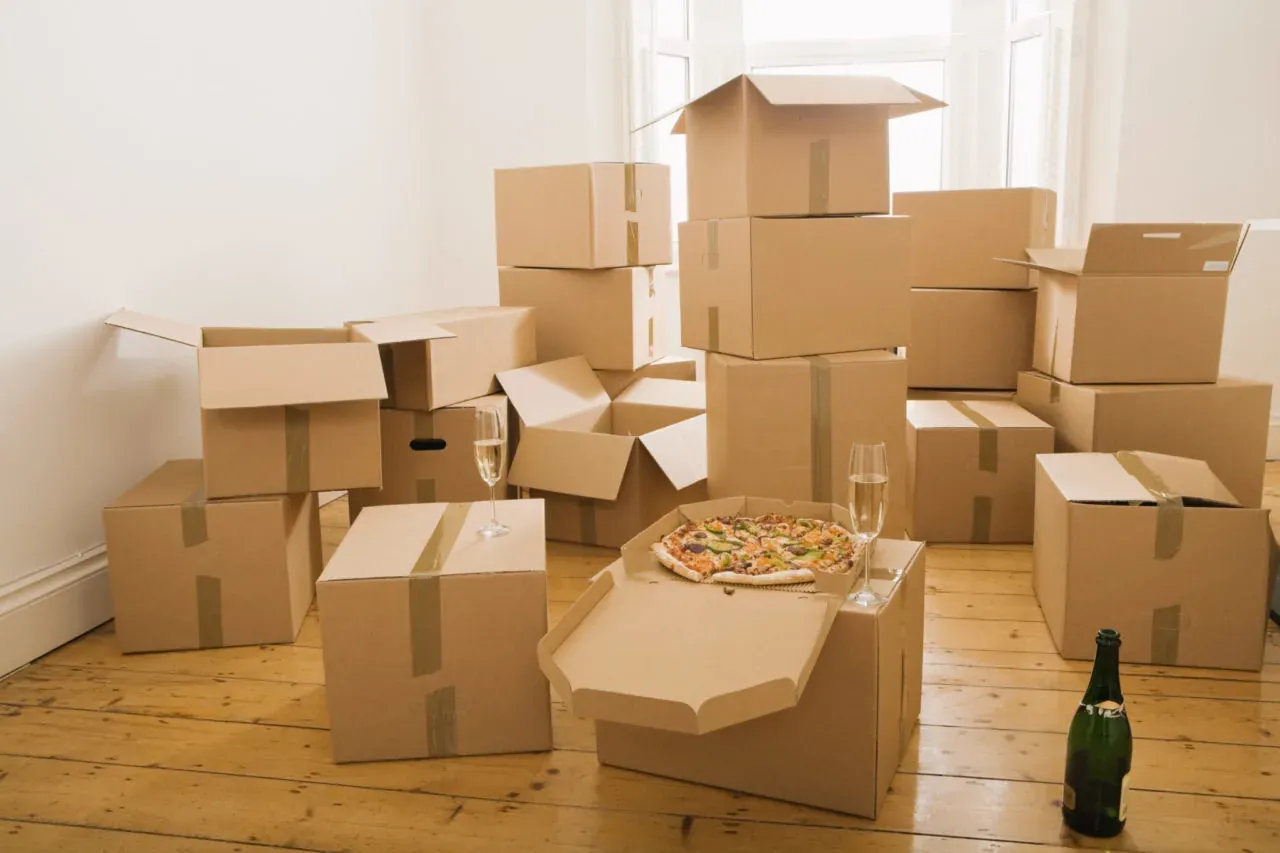 Moving boxes with pizza and champagne