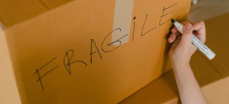 Child helping pack moving boxes at home