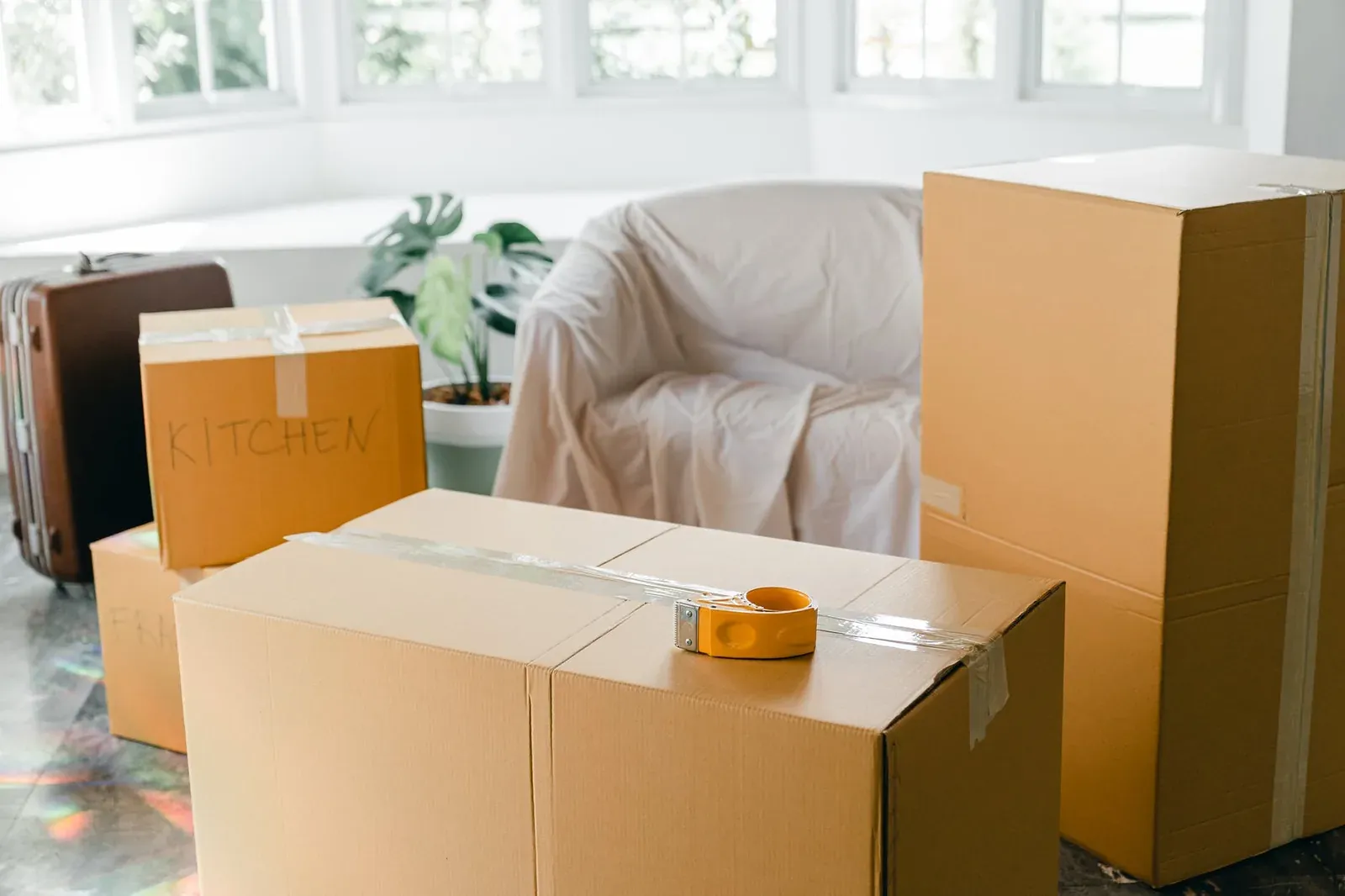 Movers preparing labeled boxes in a New Jersey home