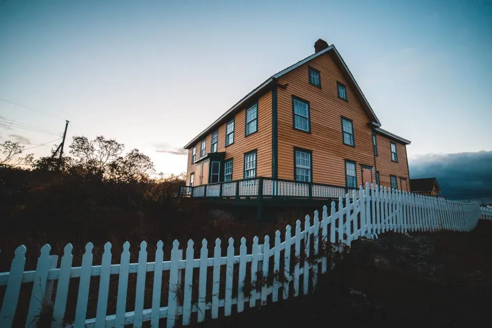 Old wooden house behind picket fence