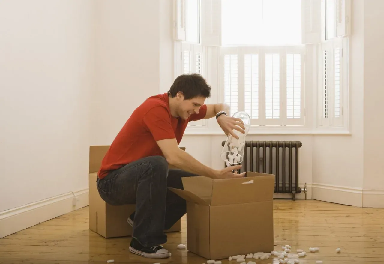 Man unpacking packing peanuts from box