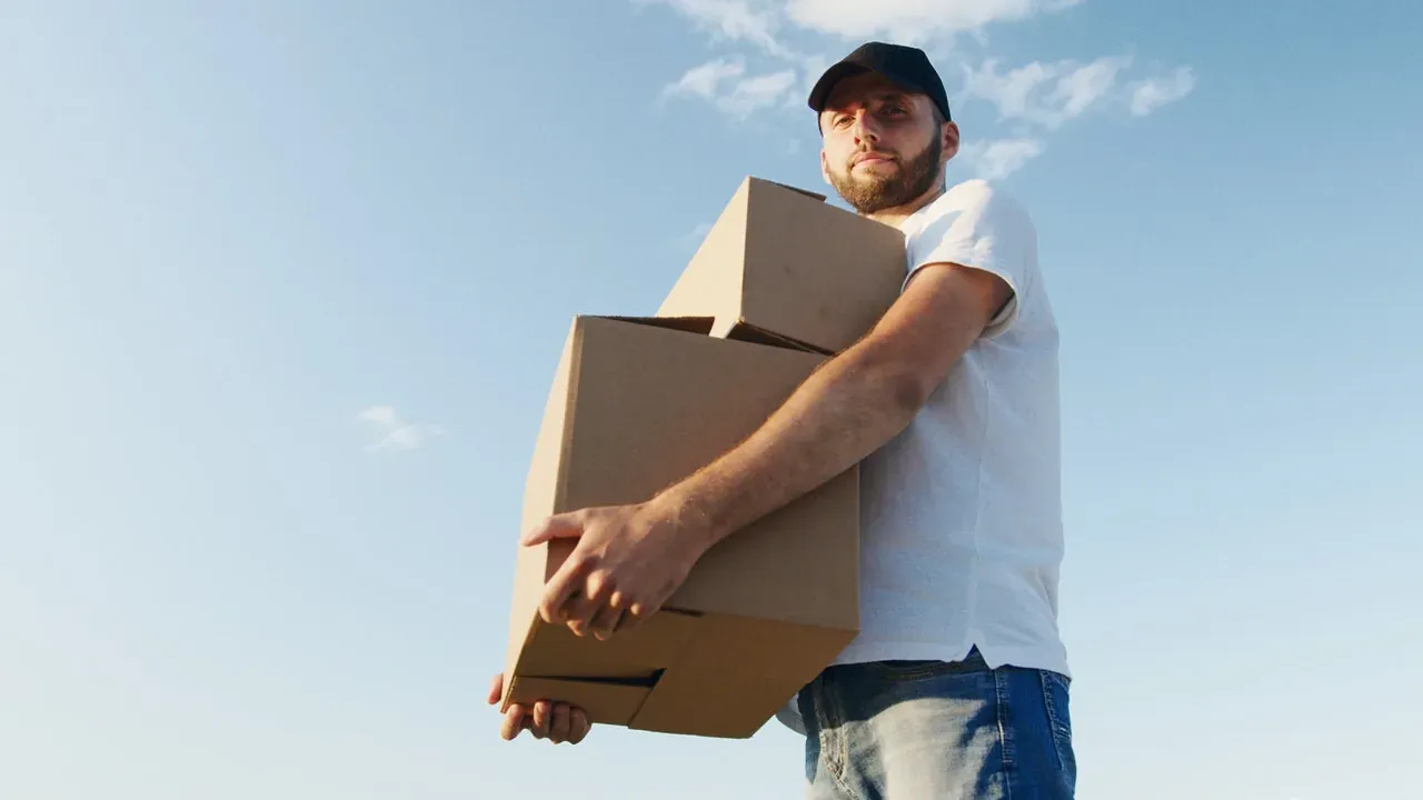 Movers loading boxes into a truck outside a New Jersey home