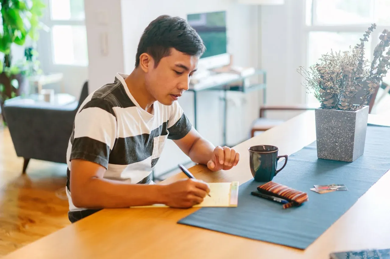 Two people reviewing moving documents at a table