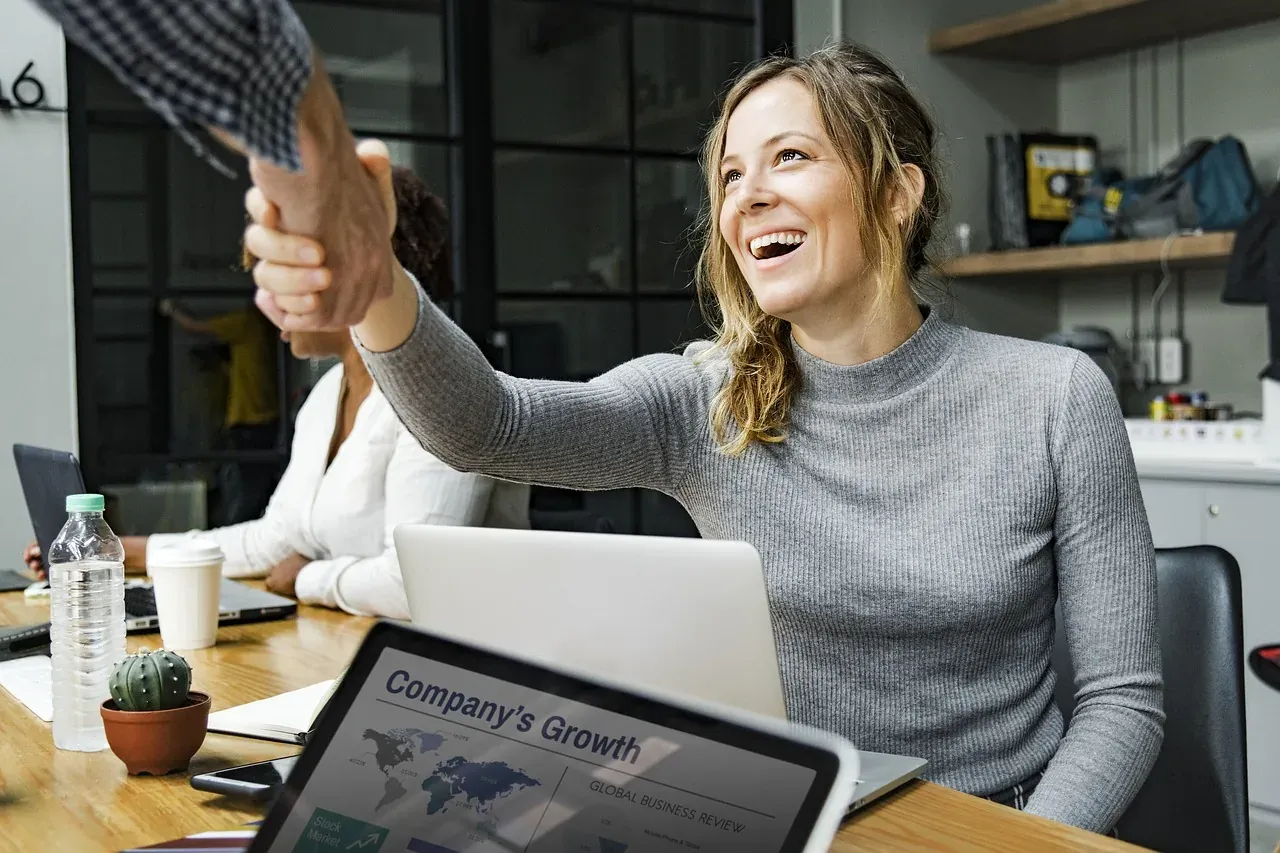 Woman shaking hands in office