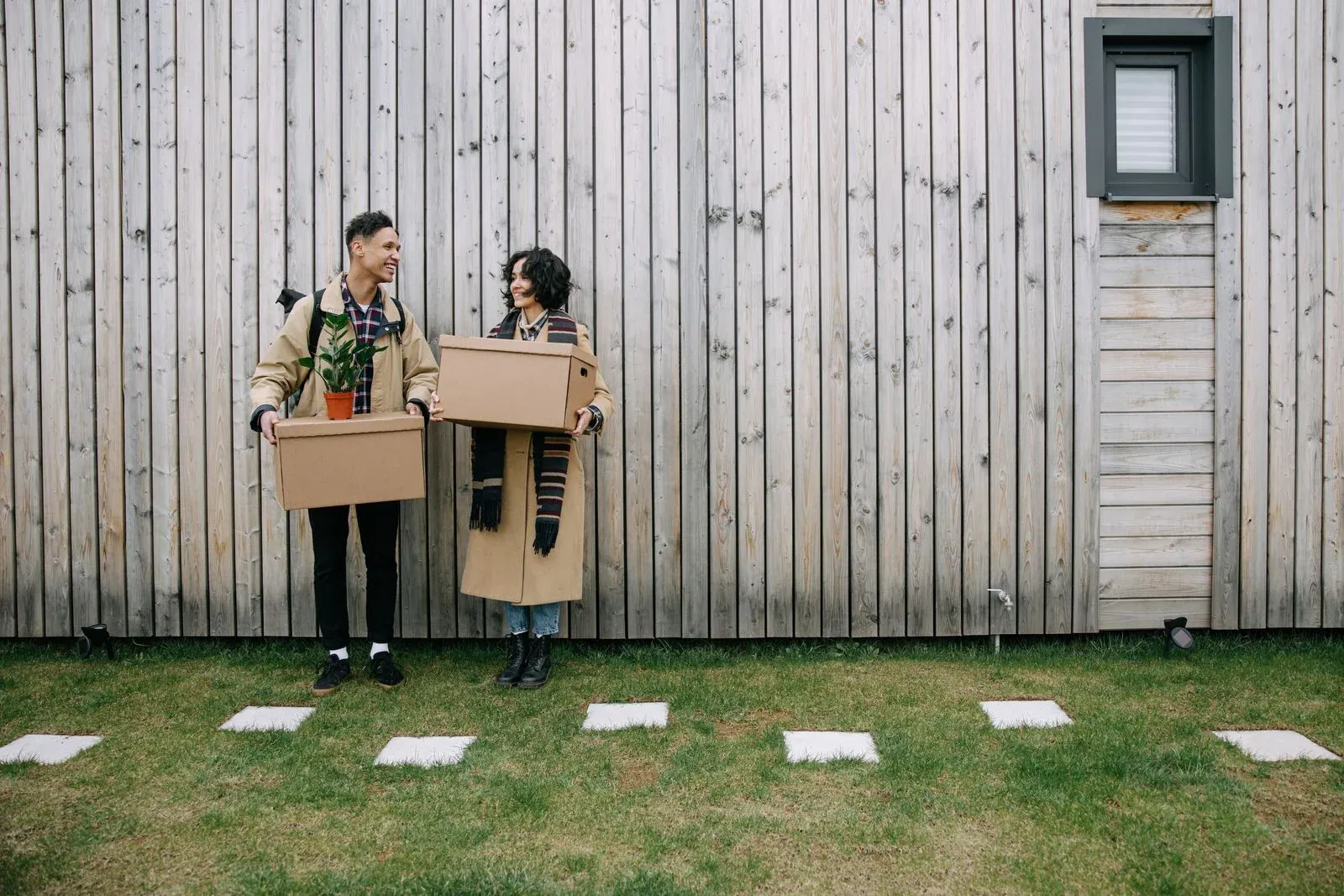 A happy couple moving into their new home