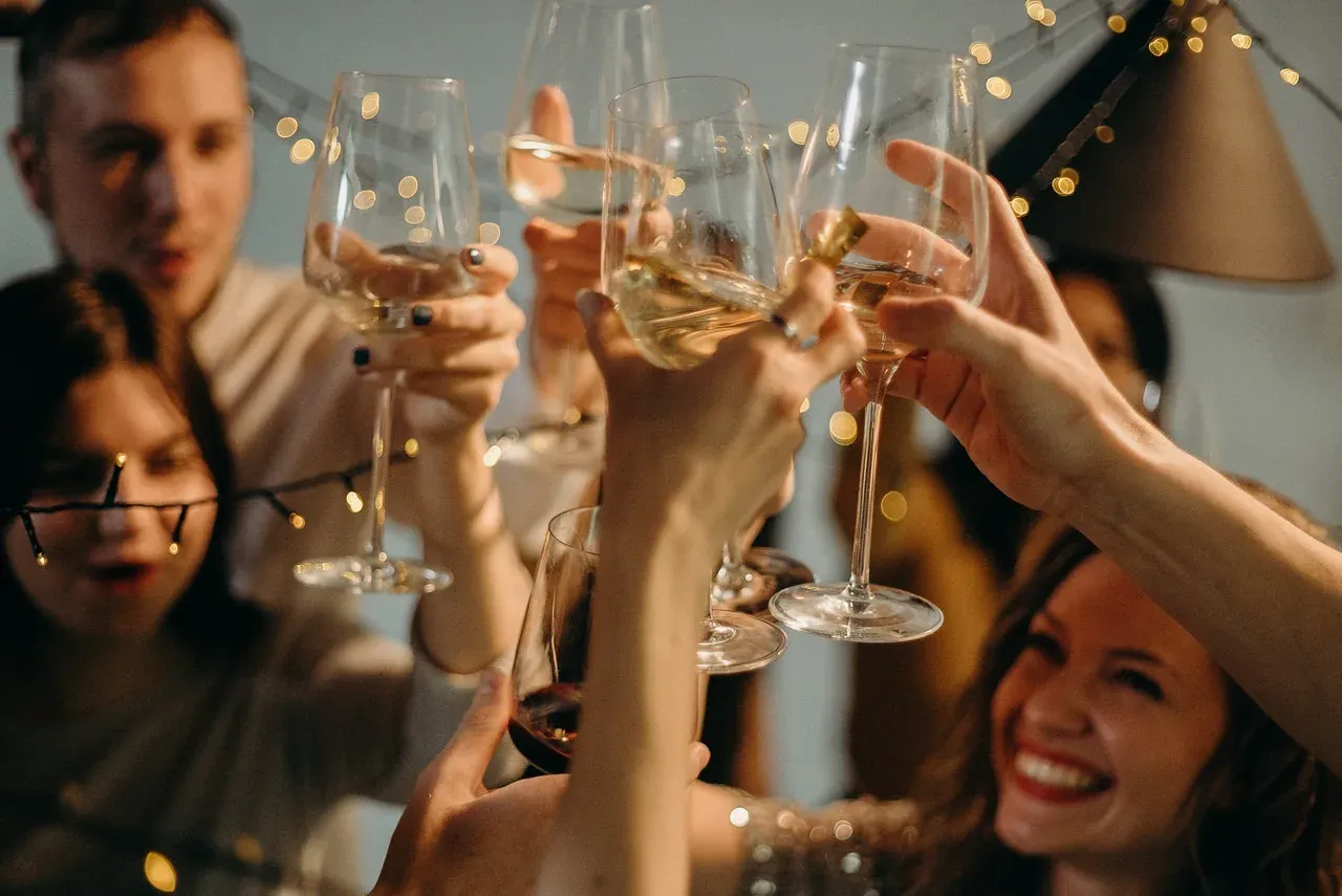 Friends raising glasses at a New Year's Eve party at home