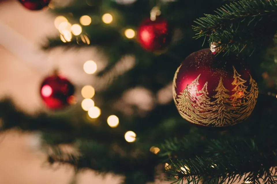 Red ornament on Christmas tree closeup